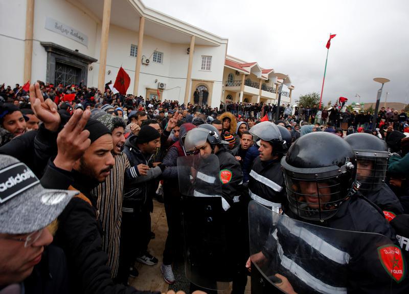 Riot police block demonstrators during a job protest after two miners died while working in a clandestine coal mine, in Jerada, Morocco, December 27, 2017.